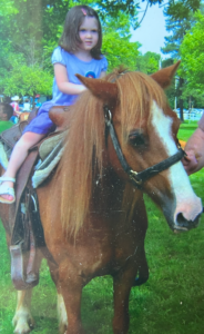 Lucy riding her first horse