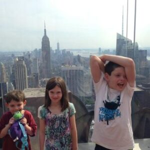 Colin, his caterpillar, Lucy, and Ethan atop Rockefeller Center in New York